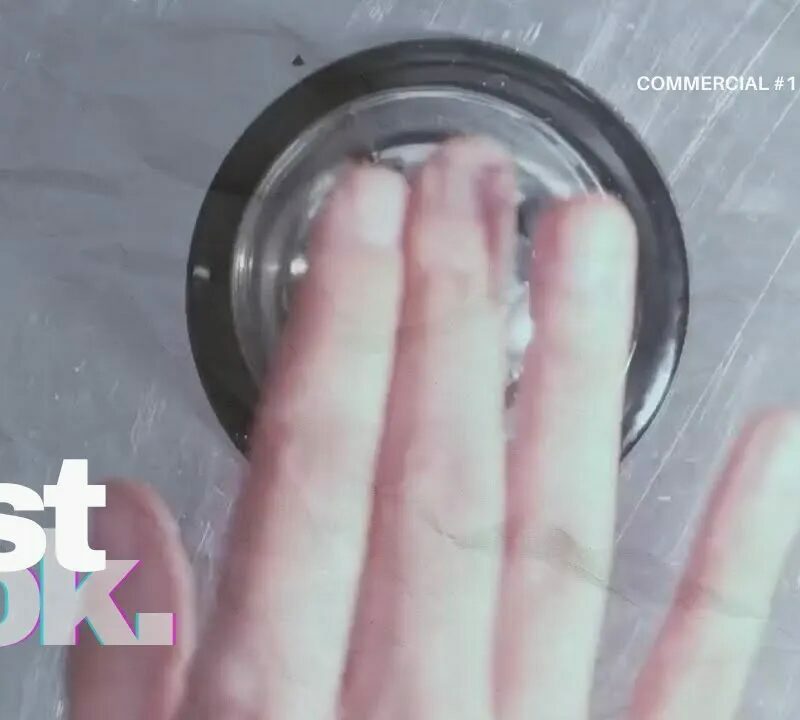 A hand pressing a buzzer with the "First Look" text overlay, part of a commercial series.