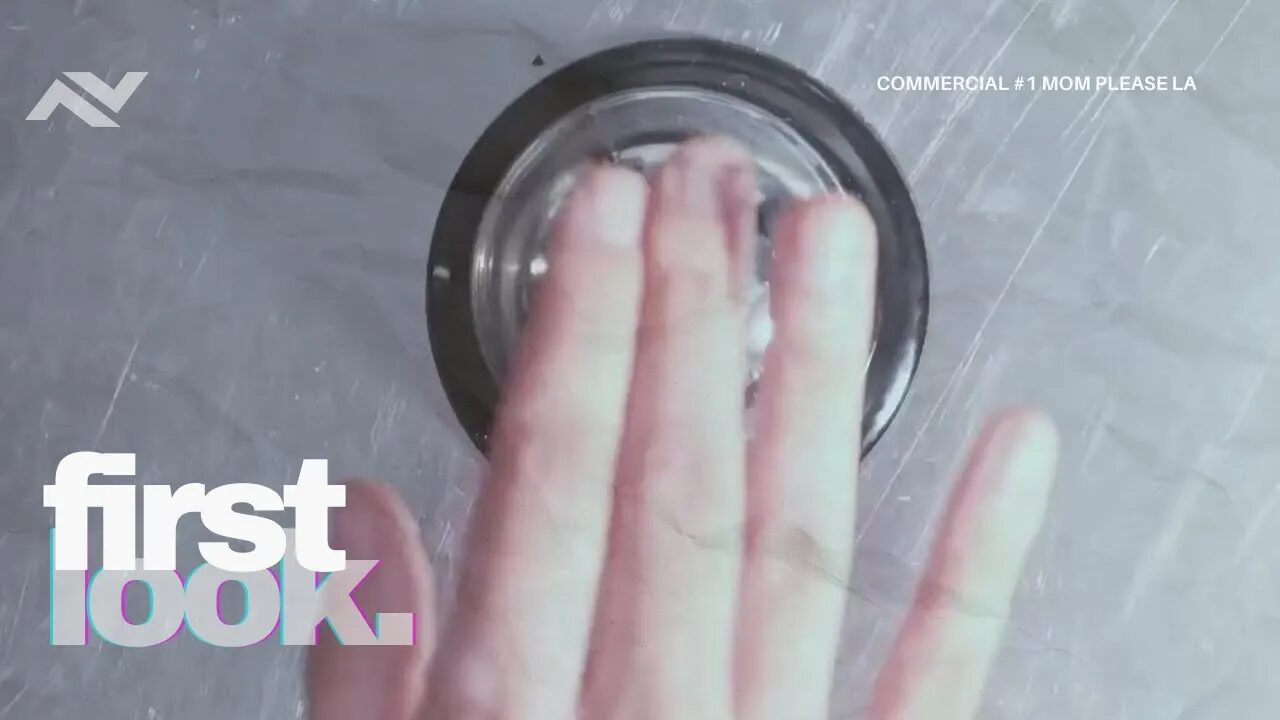 A hand pressing a buzzer with the "First Look" text overlay, part of a commercial series.